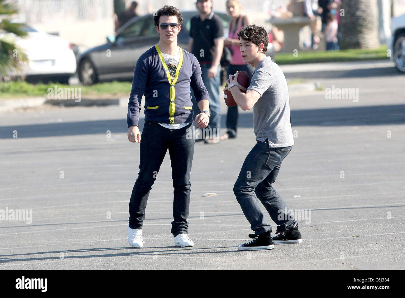 Kevin Jonas and Nick Jonas Jonas Brothers playing American football between  scenes on the set of their new film, 'Chasing Stock Photo - Alamy