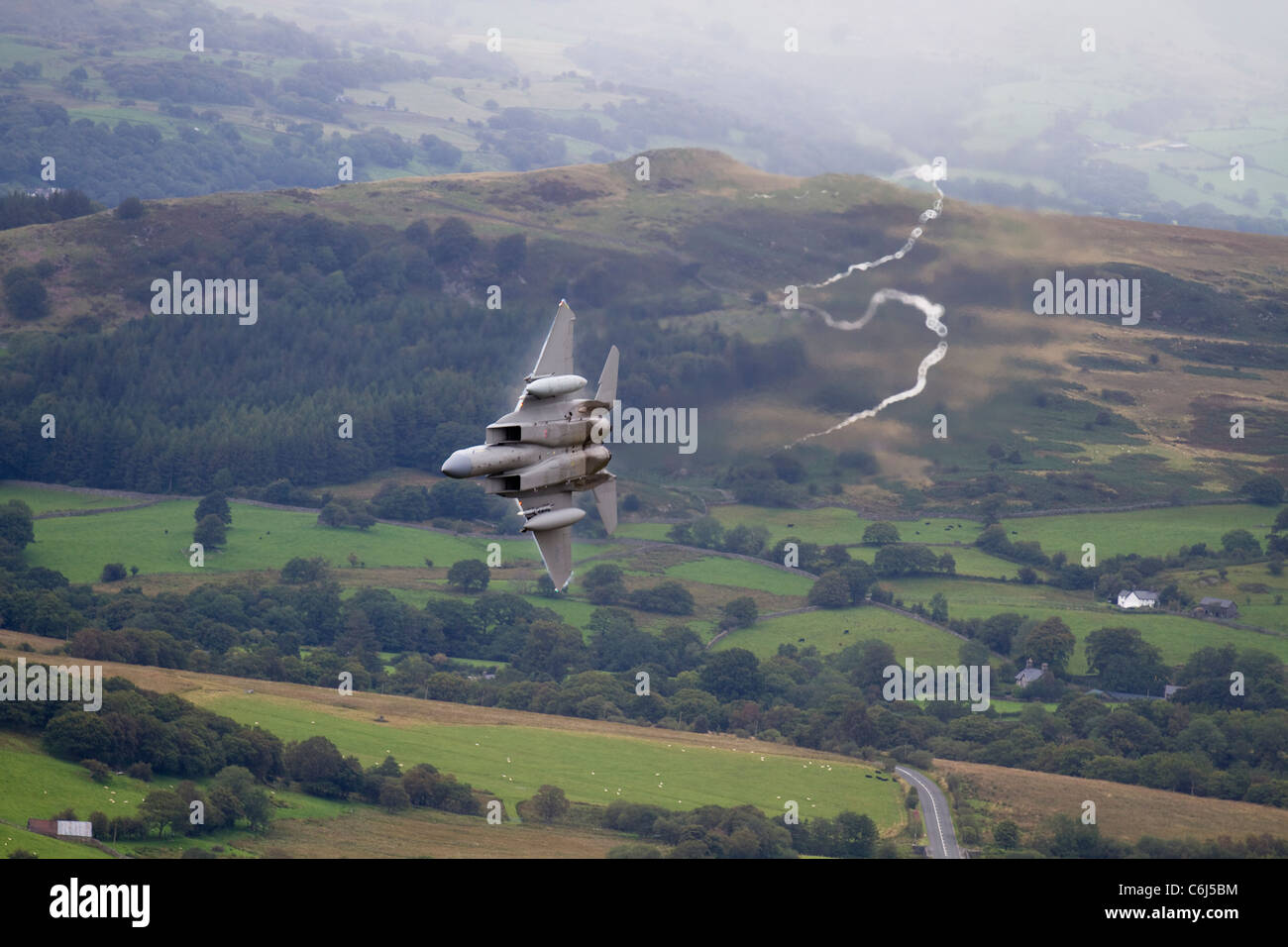 A low flying USAF F15, from 493d Fighter Squadron at RAF Lakenheath, training in the Mach Loop, Wales. Taken from Cad East Stock Photo