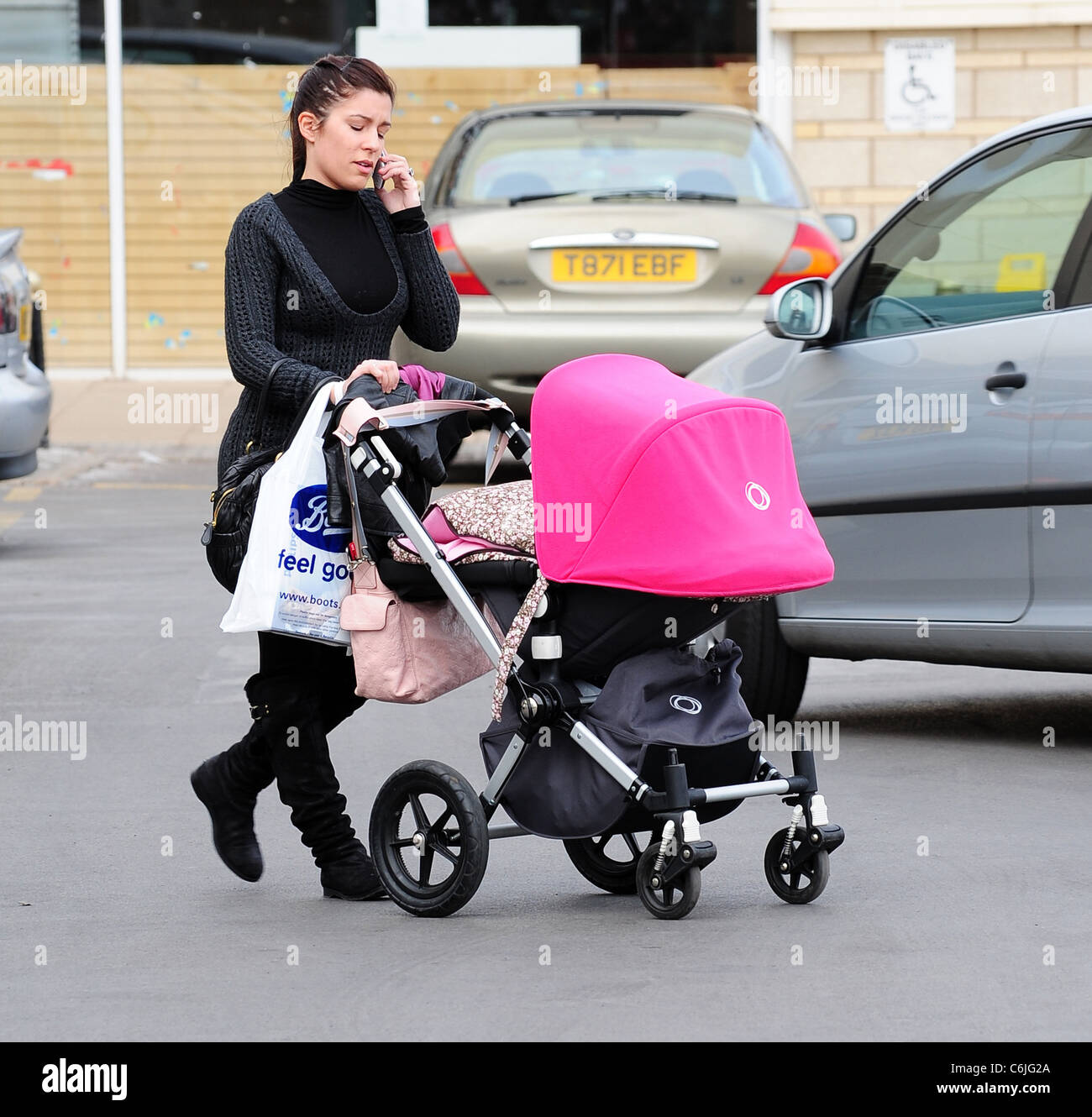 Olalla Torres, wife of Liverpool football player Fernando Torres, out shopping at Speke retail park with their daughter Nora Stock Photo