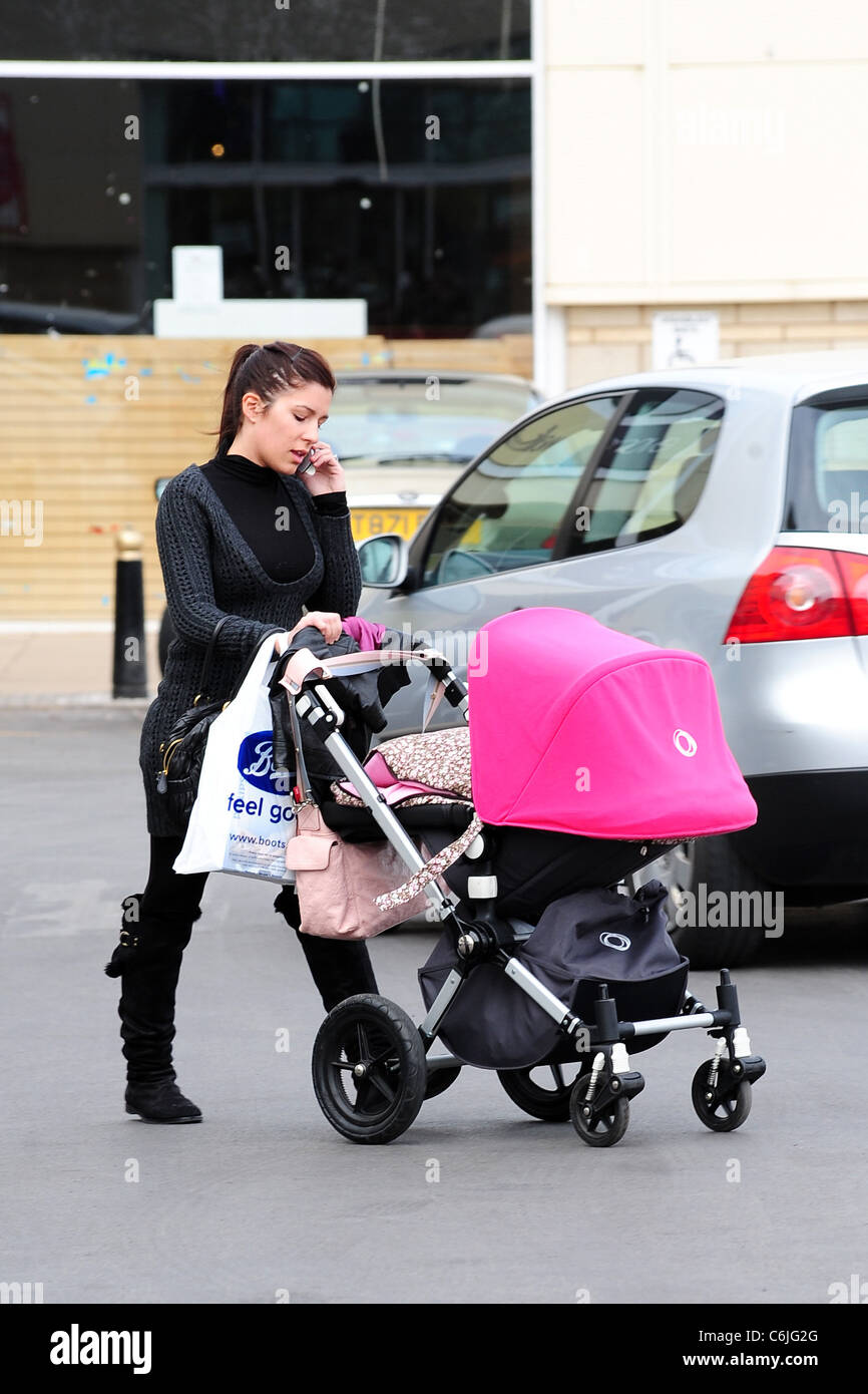 Olalla Torres, wife of Liverpool football player Fernando Torres, out shopping at Speke retail park with their daughter Nora Stock Photo