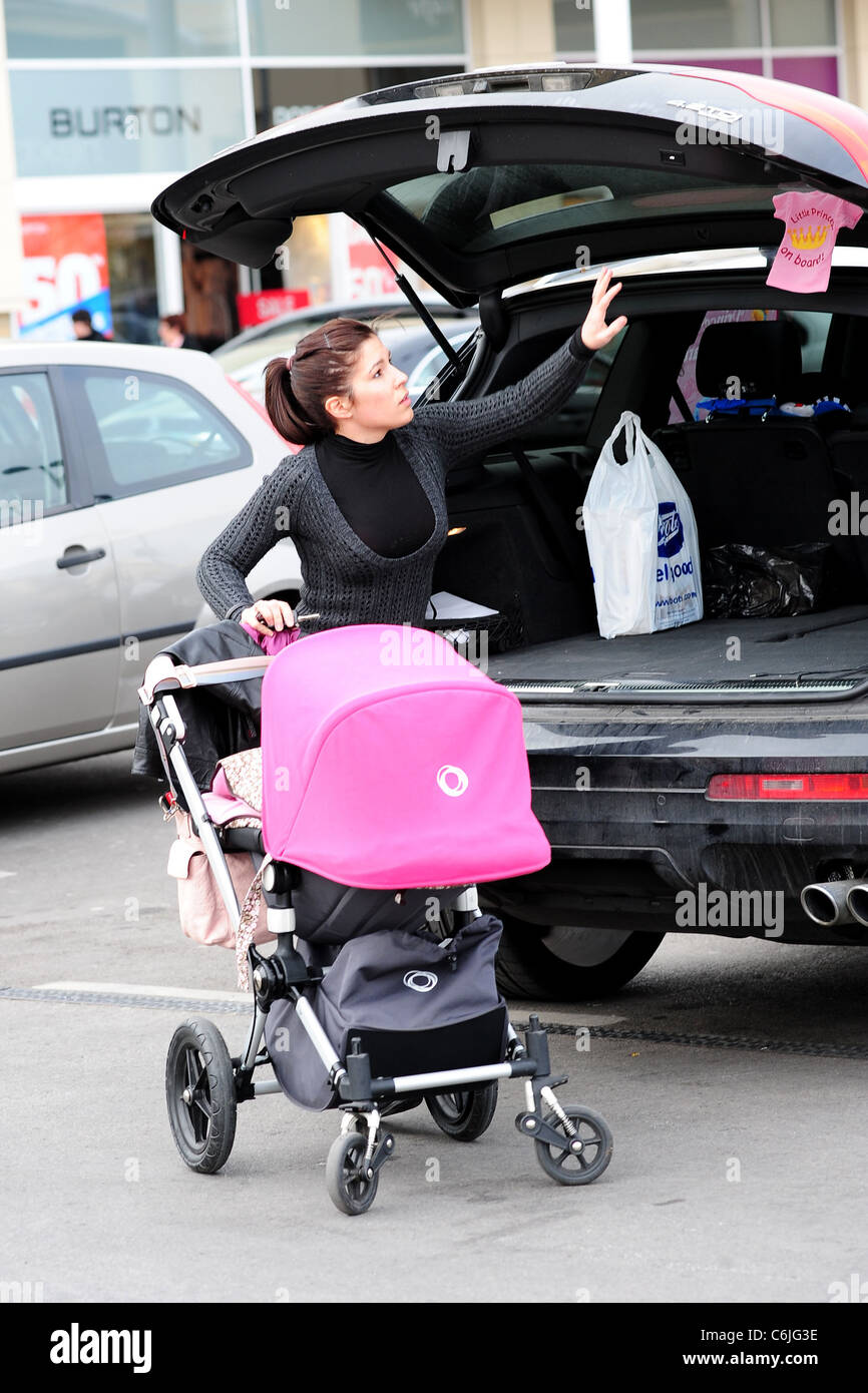 Olalla Torres, wife of Liverpool football player Fernando Torres, out shopping at Speke retail park with their daughter Nora Stock Photo