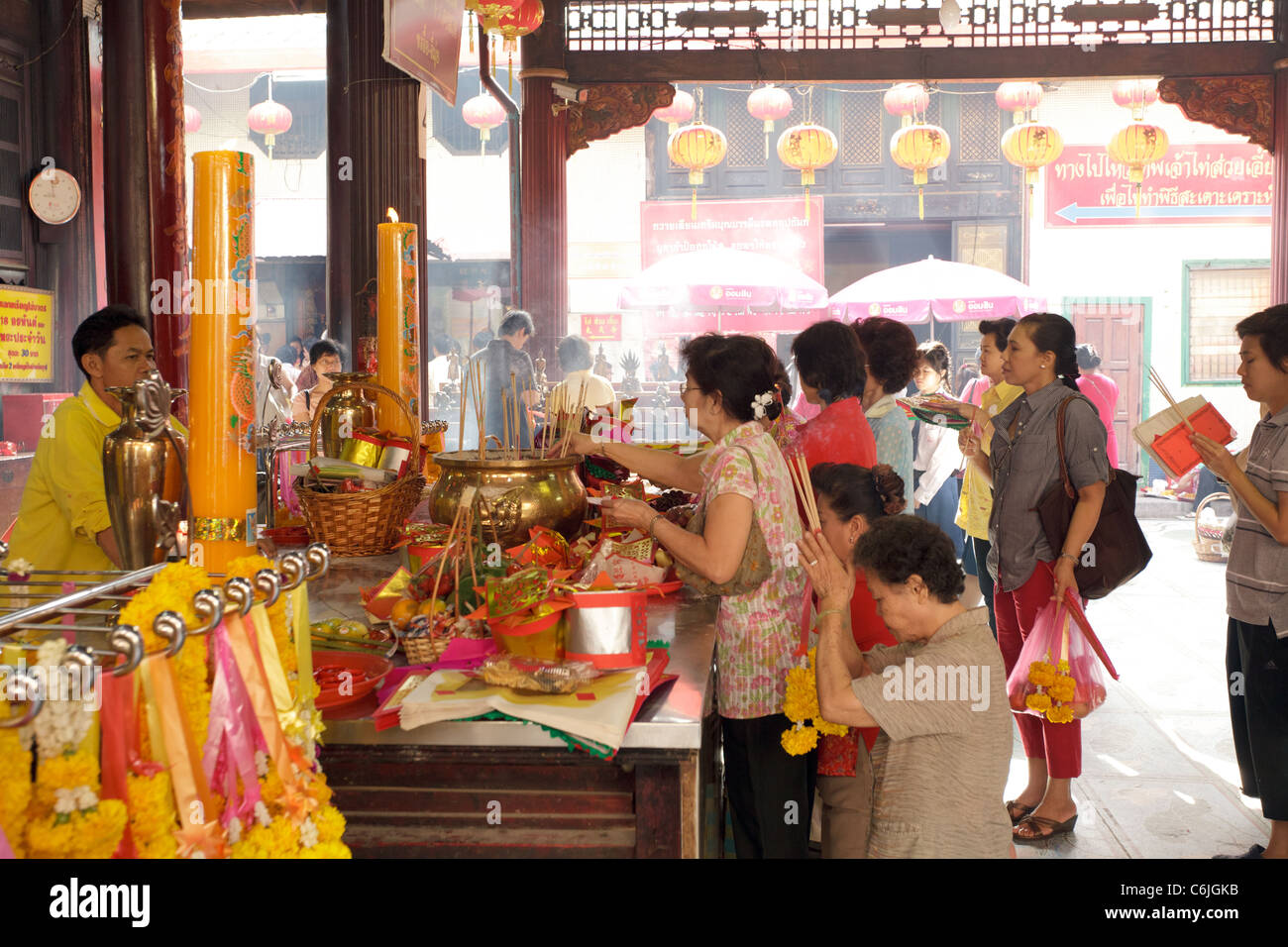 chinese people praying in chinese taoist temple in bangkok, thailand