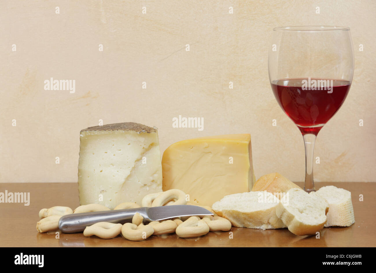 Still life of wine and cheeses with bread Stock Photo - Alamy