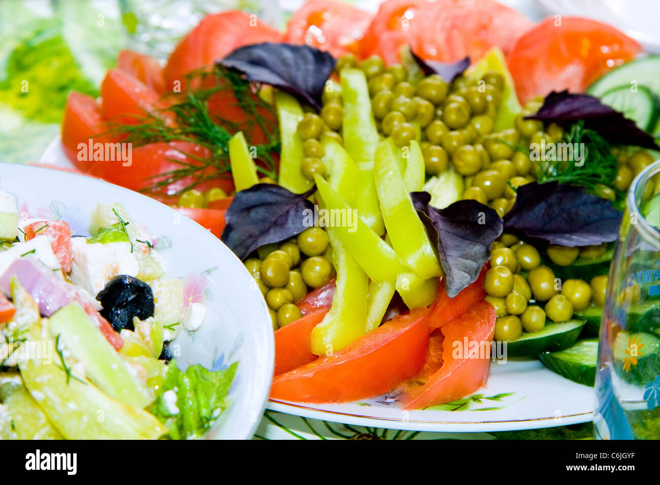 Fresh salad with tomatoes, peas, cucumber, basil, green pepper Stock Photo