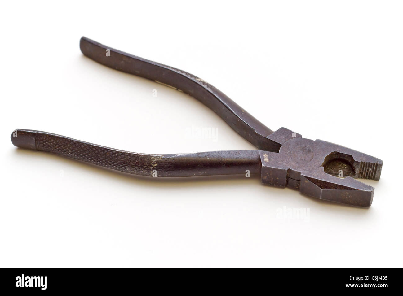 A pair of old rusty metal pliers on a white background Stock Photo