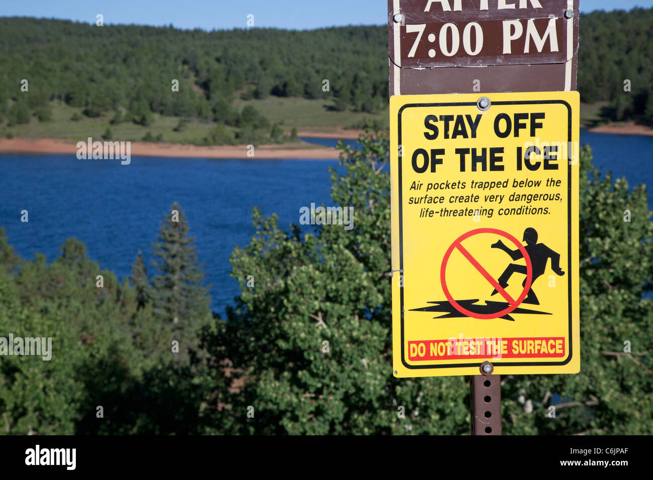 Colorado Springs, Colorado - A sign warns visitors to stay off the ice on Crystal Creek Reservoir on Pikes Peak. Stock Photo