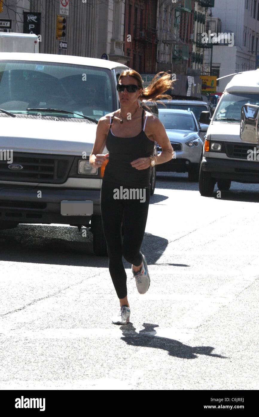 Kelly Bensimon, star of 'The Real Housewives of New York City', jogging on  a busy Manhattan street New York City, USA Stock Photo - Alamy