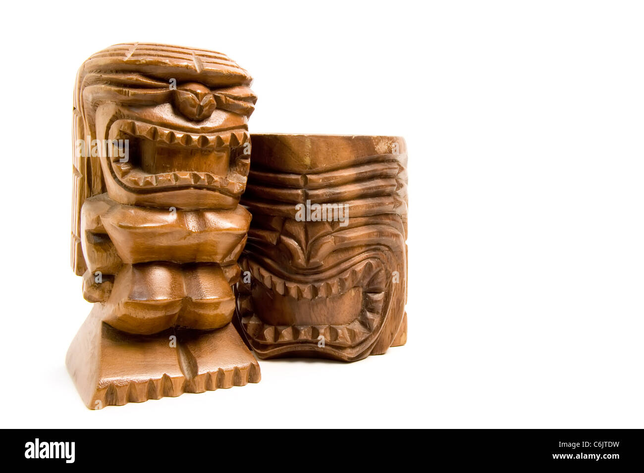 two carved wooden tiki figurines, isolated on white Stock Photo Alamy
