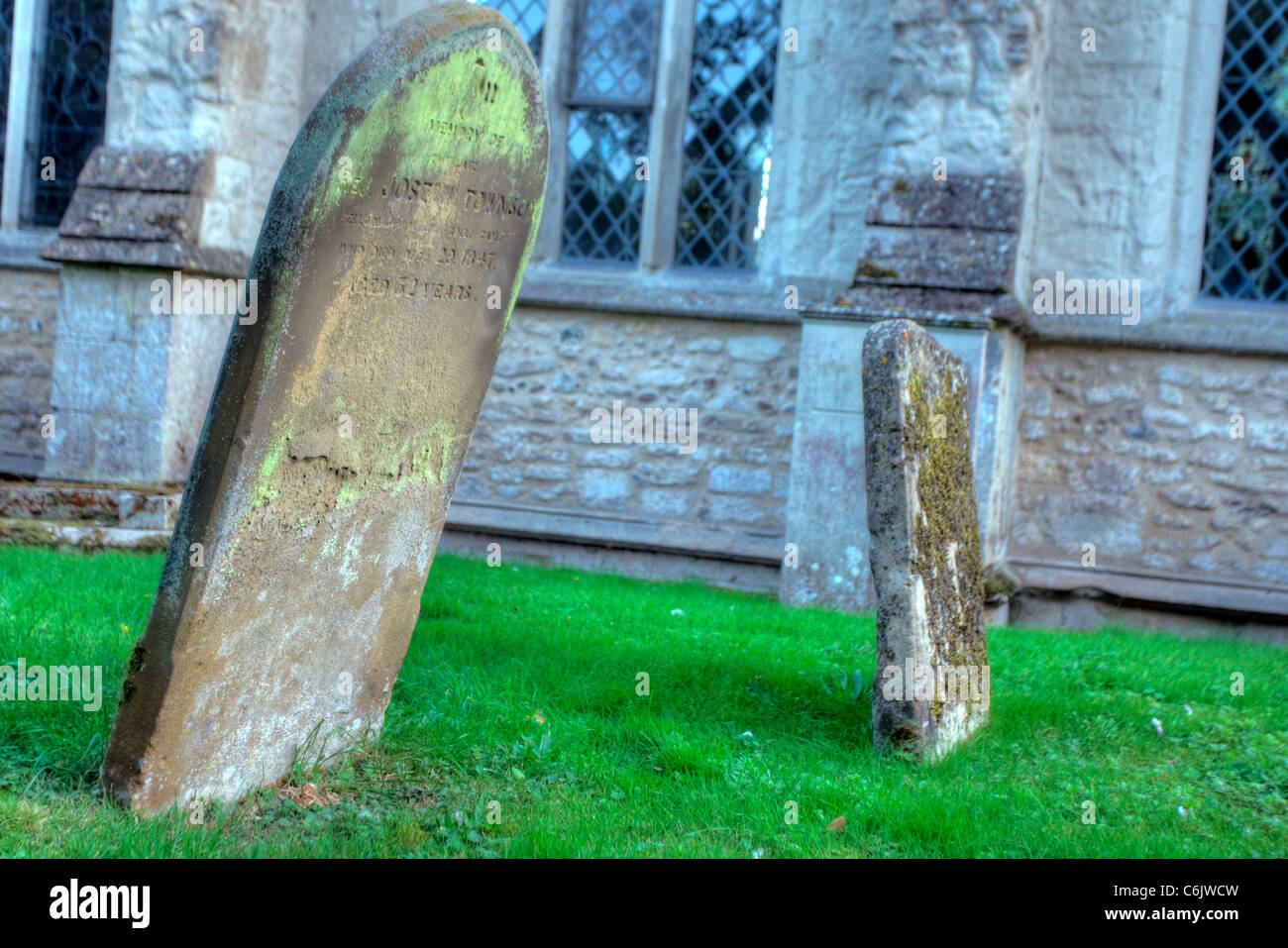 Old gravestones outside a church Stock Photo