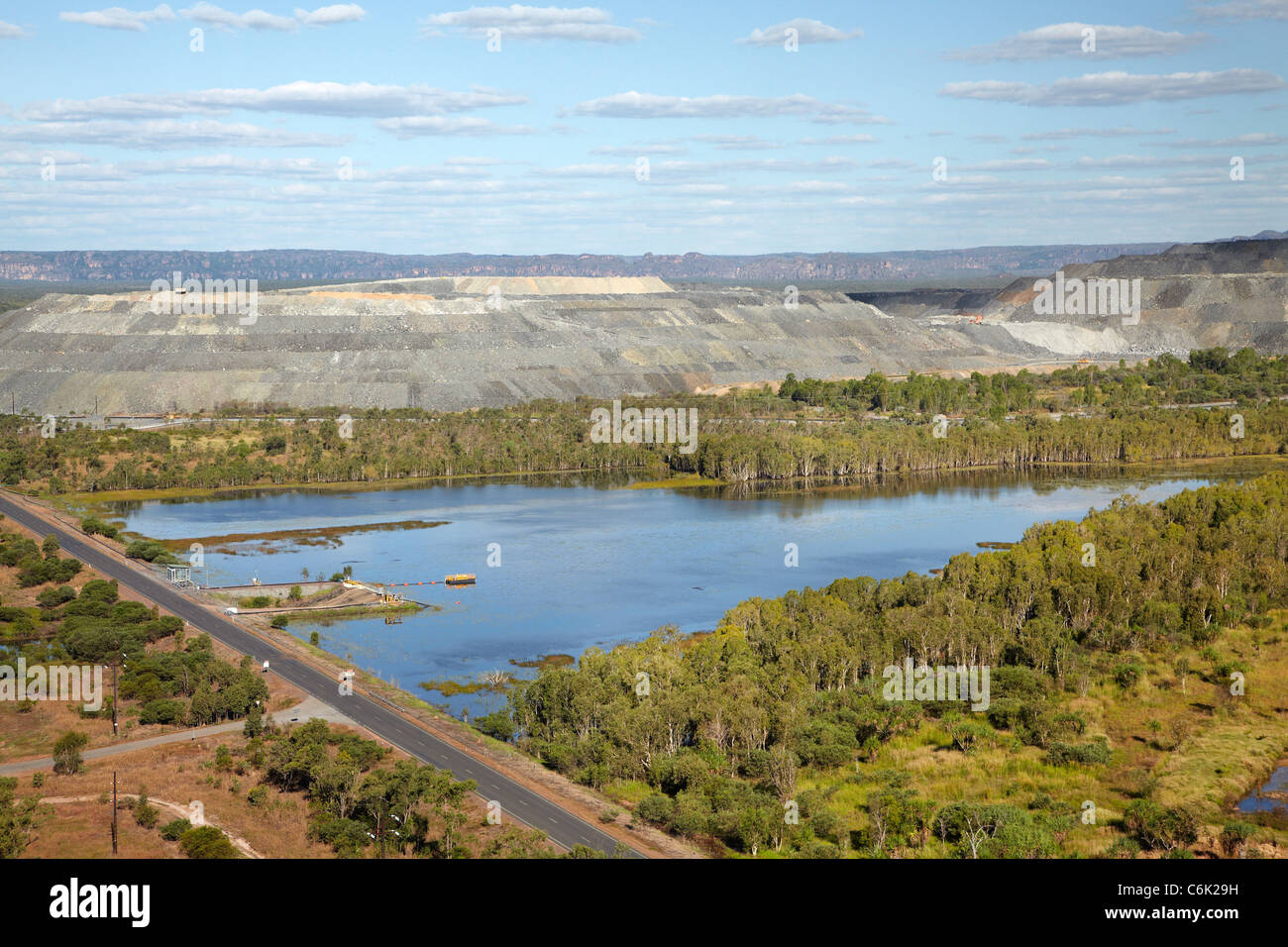 Retention pond, and uranium ore stockpile, Ranger Uranium Mine, Kakadu National Park, Northern Territory, Australia - aerial Stock Photo