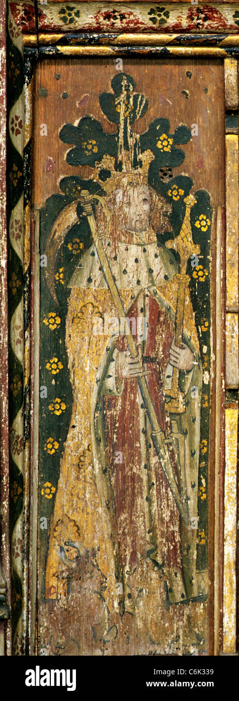 Sparham, Norfolk. Rood screen, St. Walstan of Bawburgh, the agricultural saint holding scythe, sceptre, ox oxen at his feet Stock Photo