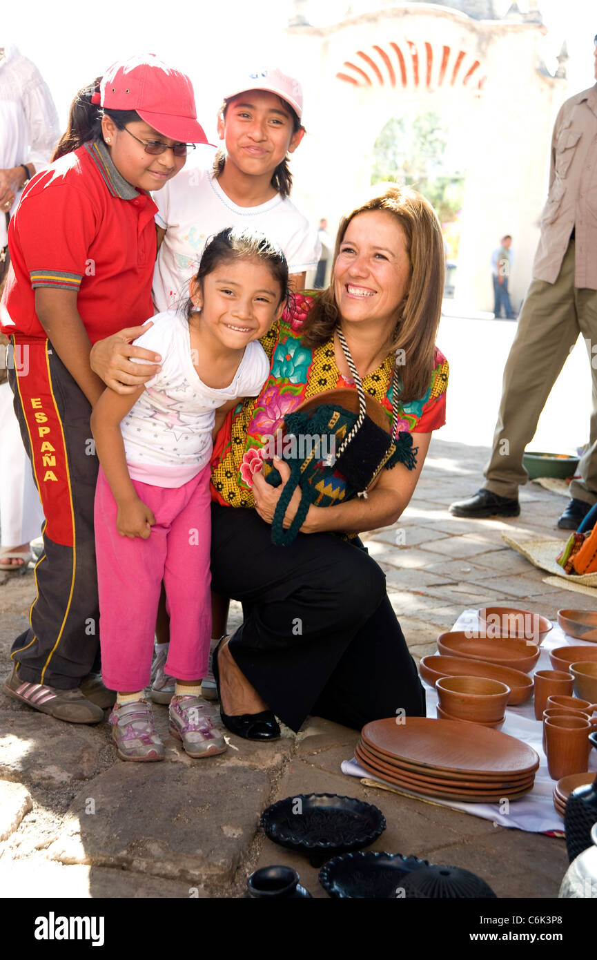 First lady of Mexico Margarita Zavala Calderon greets a young girl while shopping at an outdoor market  in a small village Stock Photo