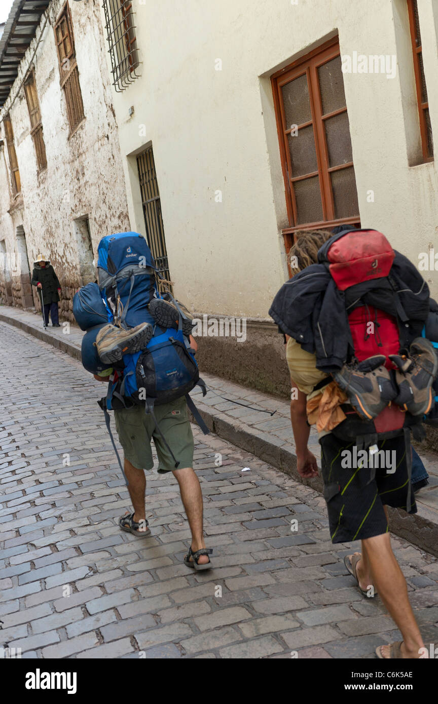 Carrying two cheap backpacks