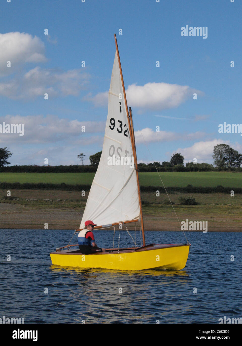 Young boy sailing a Heron Dinghy. Wimbleball Lake ...