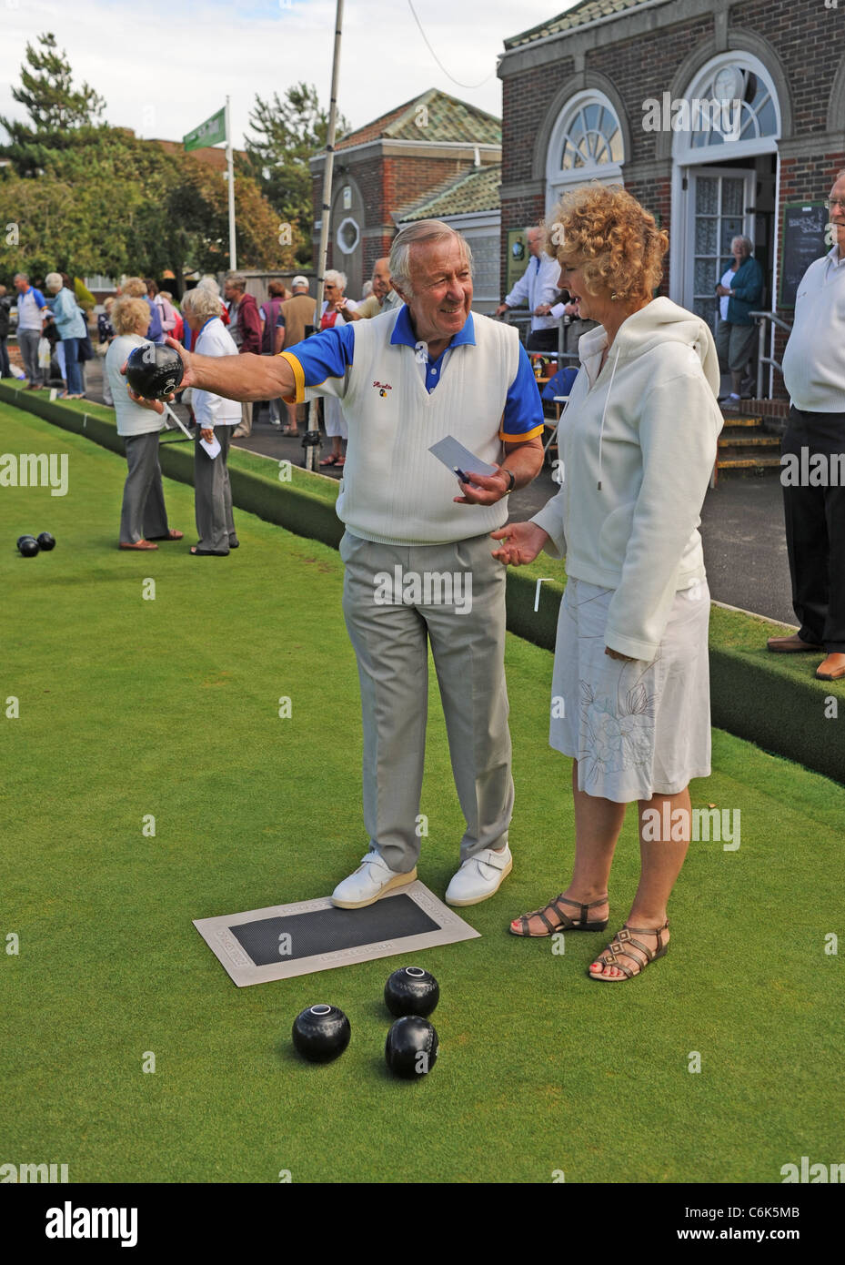 Expert bowlers giving instruction to newcomers at the Worthing Marine Gardens Bowls Club in Worthing West Sussex UK Stock Photo