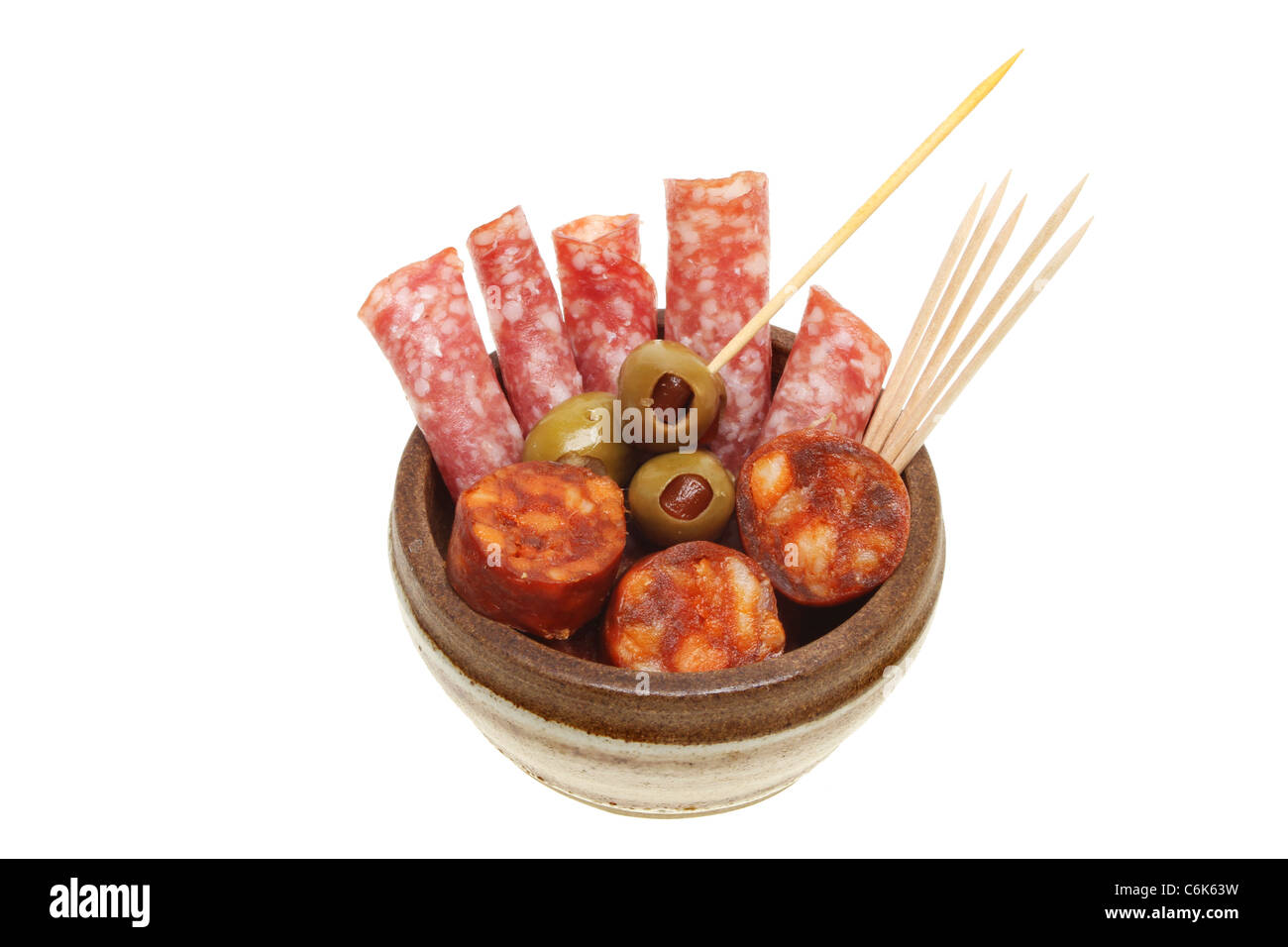 Salami and chorizo sausage in a bowl with stuffed olives and cocktail sticks Stock Photo