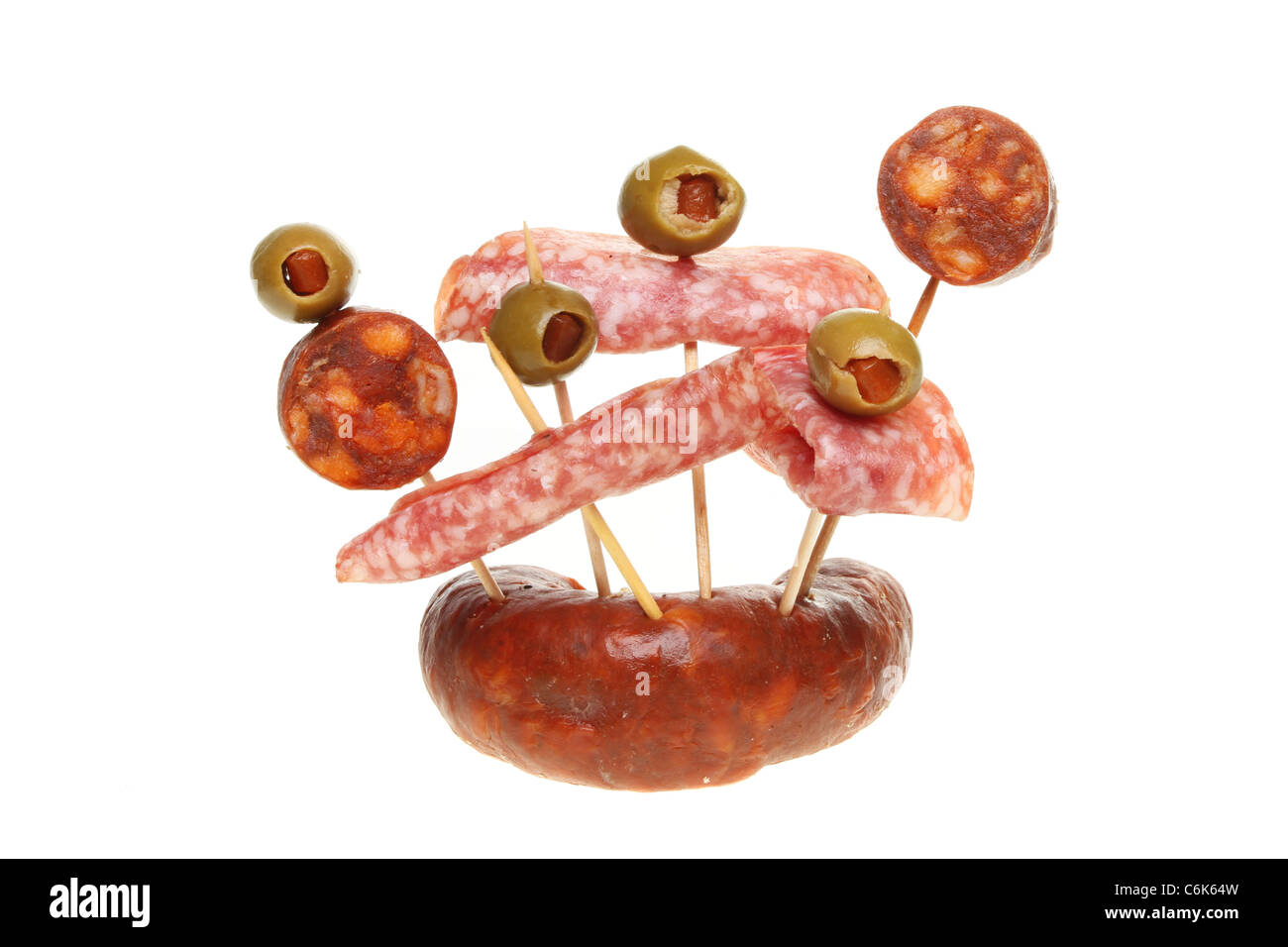 Selection of salami and chorizo sausage meats with olives on cocktail sticks Stock Photo