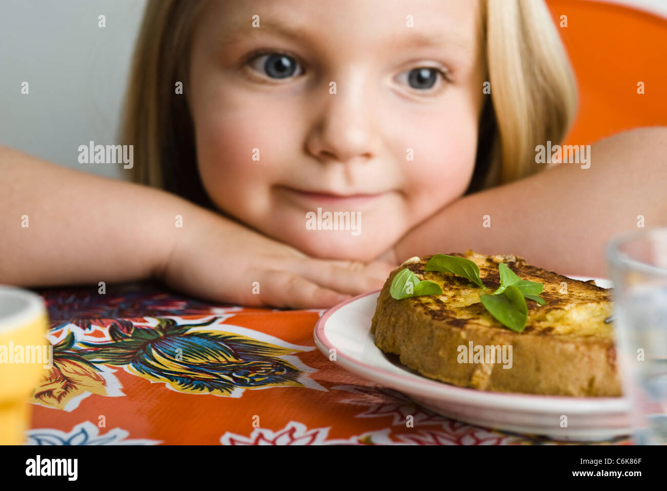 Little girl preparing to eat savory french toast Stock Photo Alamy