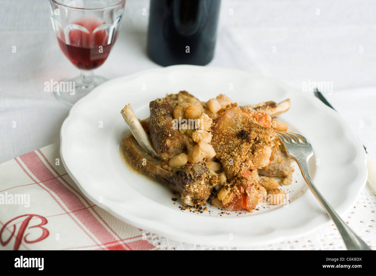 Cassoulet with fresh beans, served with red wine Stock Photo