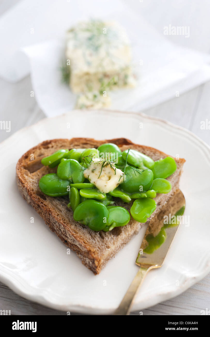 Sliced bread topped with peas and pastis butter Stock Photo