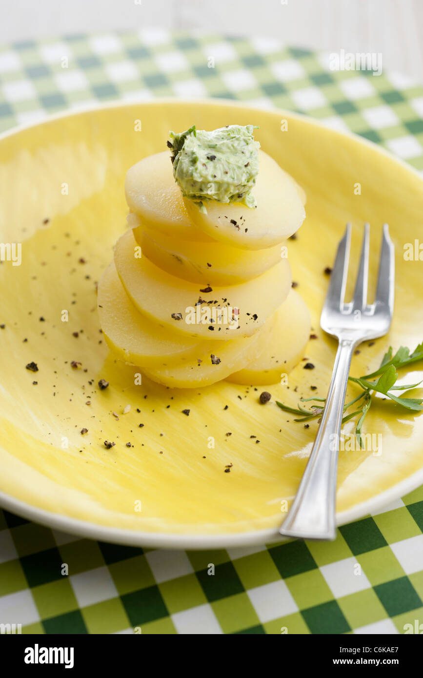 Watercress butter on sliced potatoes Stock Photo