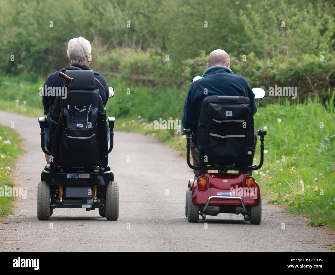 Couple on mobility scooters, Bude, Cornwall, UK Stock Photo