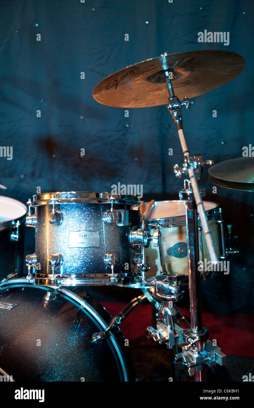 Grey drumkit against blue background Stock Photo