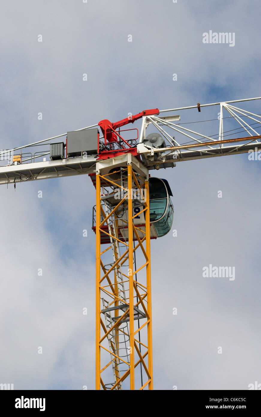 A building construction crane against cloudy blue sky Stock Photo - Alamy