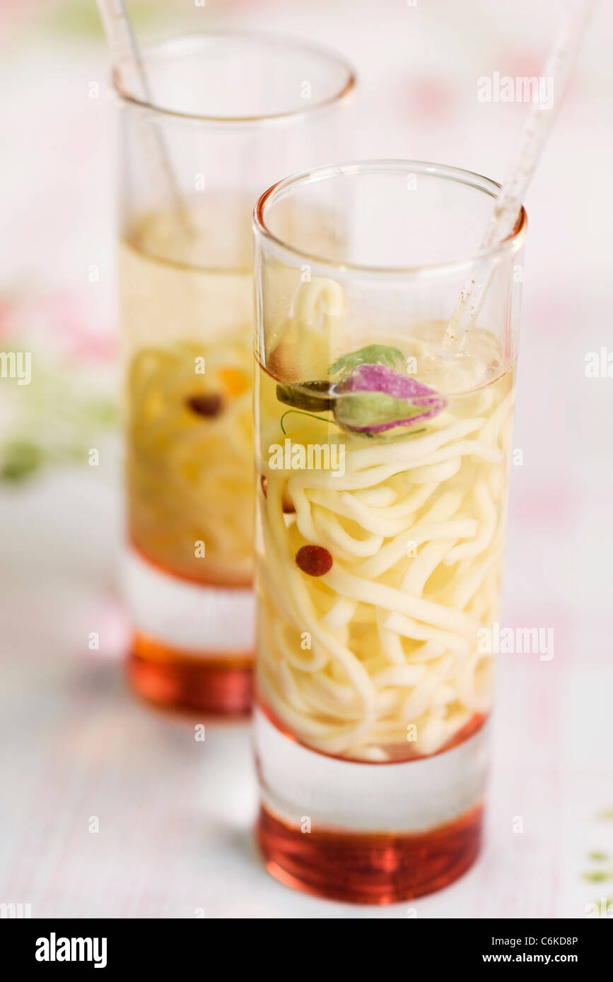 Chicken and rose soup with spaghettini Stock Photo