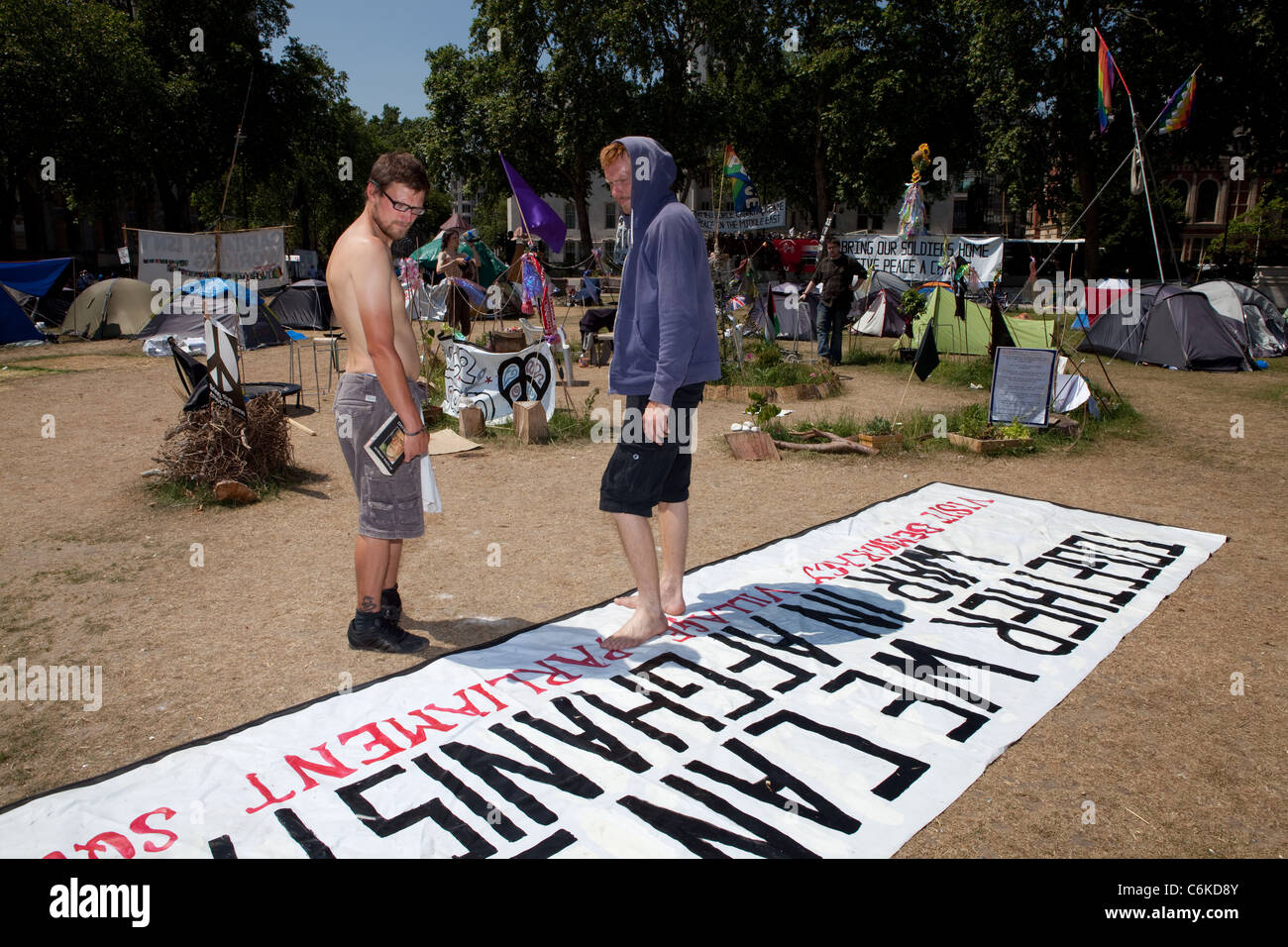 Activists, Dean and Gareth take down an anti-war banner at Democracy Village. Stock Photo