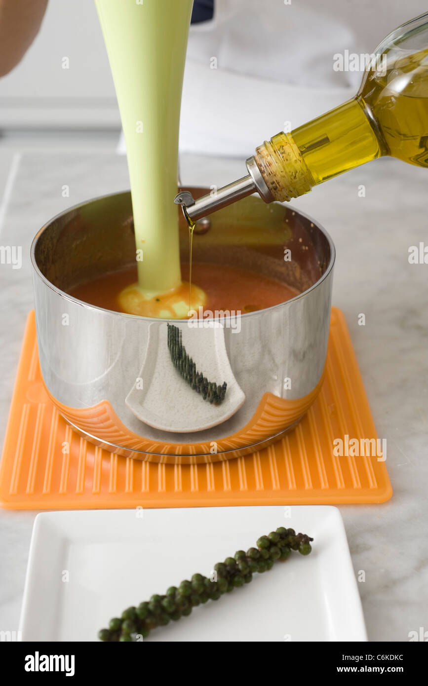 Tomato soup with green peppercorns and buffalo mozzarella Stock Photo