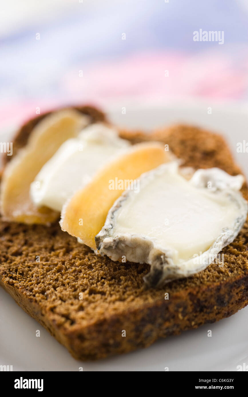 Sliced gingerbread with goat cheese and candied ginger Stock Photo