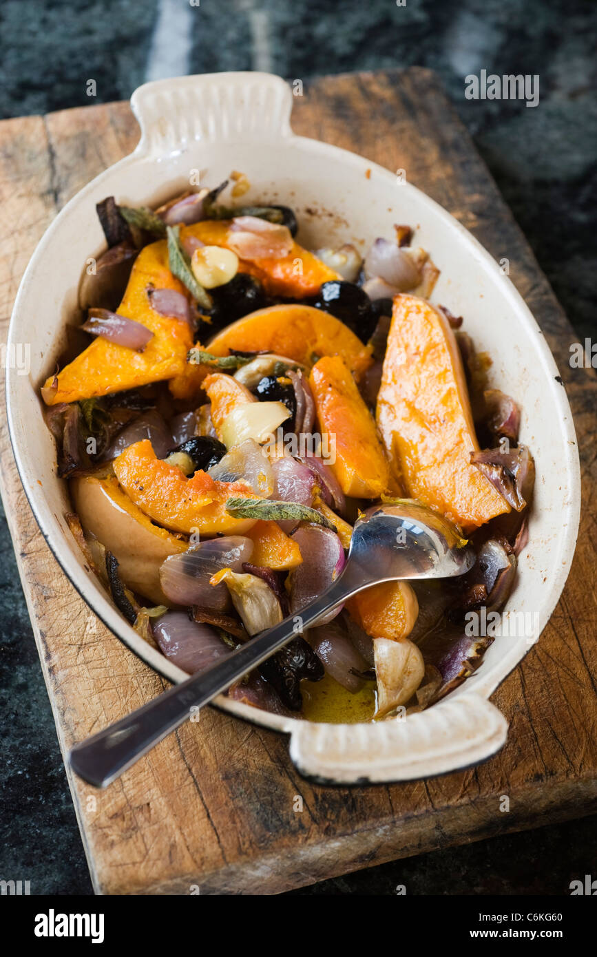 Butternut squash confit with black olives and sage Stock Photo