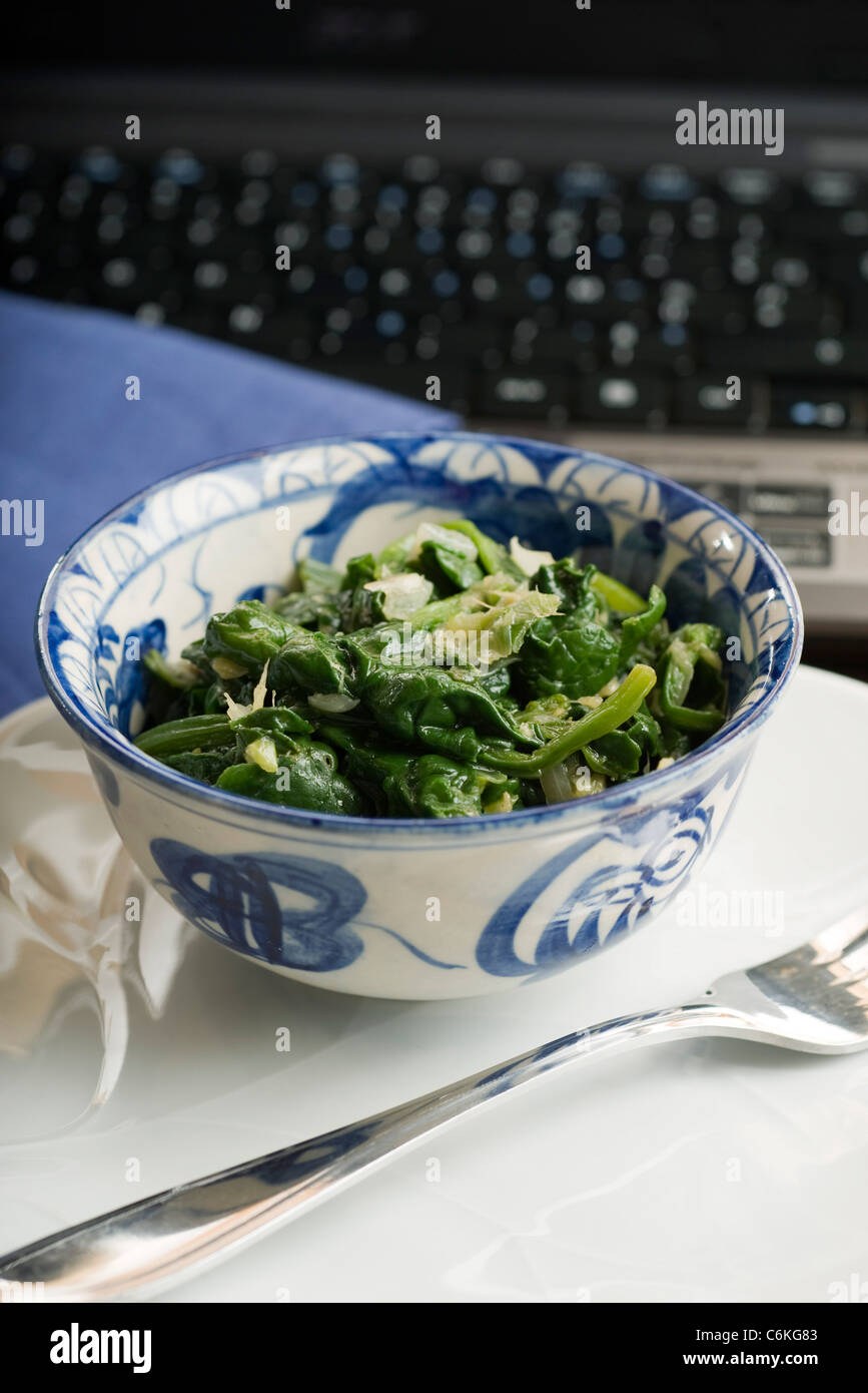 Sauteed spinach with onions and ginger Stock Photo - Alamy