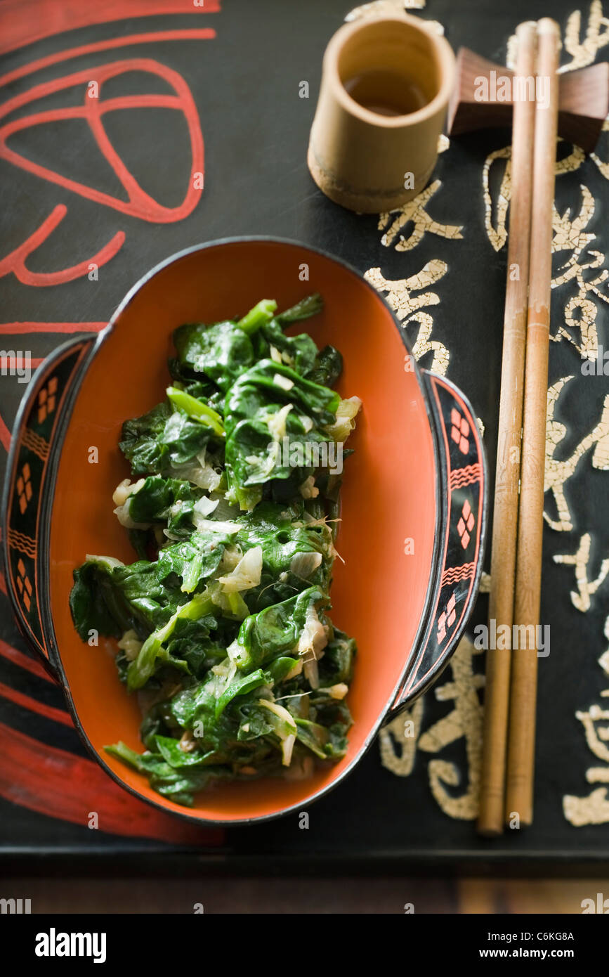 Sauteed spinach with onions and ginger Stock Photo - Alamy