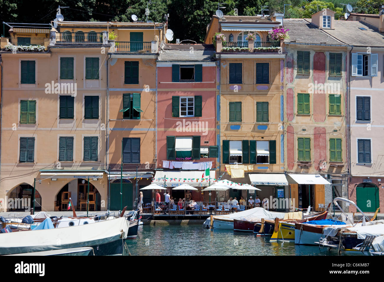 Paste-coloured house facades and harbour restaurant at fishing village Portofino, Liguria di Levante, italian riviera, Italy, Mediterranean sea Stock Photo