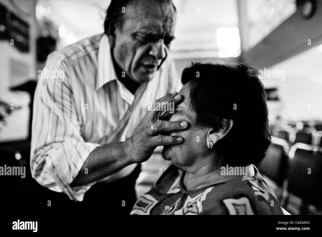 Pastor Hugo Alvarez performs the exorcism ritual on a follower of the Church of the Divine Saviour in Mexico City, Mexico. Stock Photo