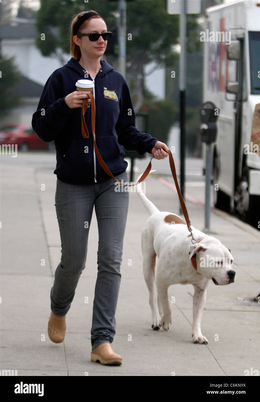Judy Greer drinking coffee while out walking her dog in West