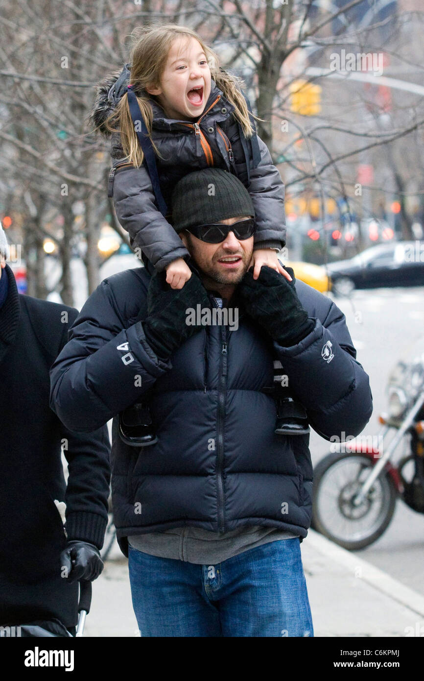 Hugh Jackman carries his daughter Ava Eliot Jackman while walking through Greenwich Village New