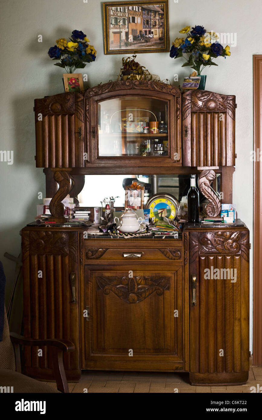 Cabinet Cluttered With Knickknacks And Other Household Objects