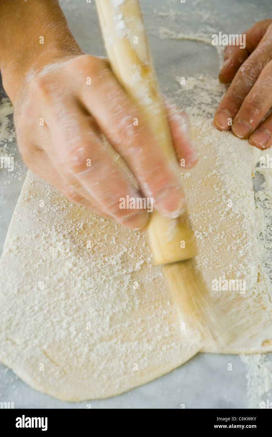 Making lasagna noodles, dusting pasta dough with flour Stock Photo
