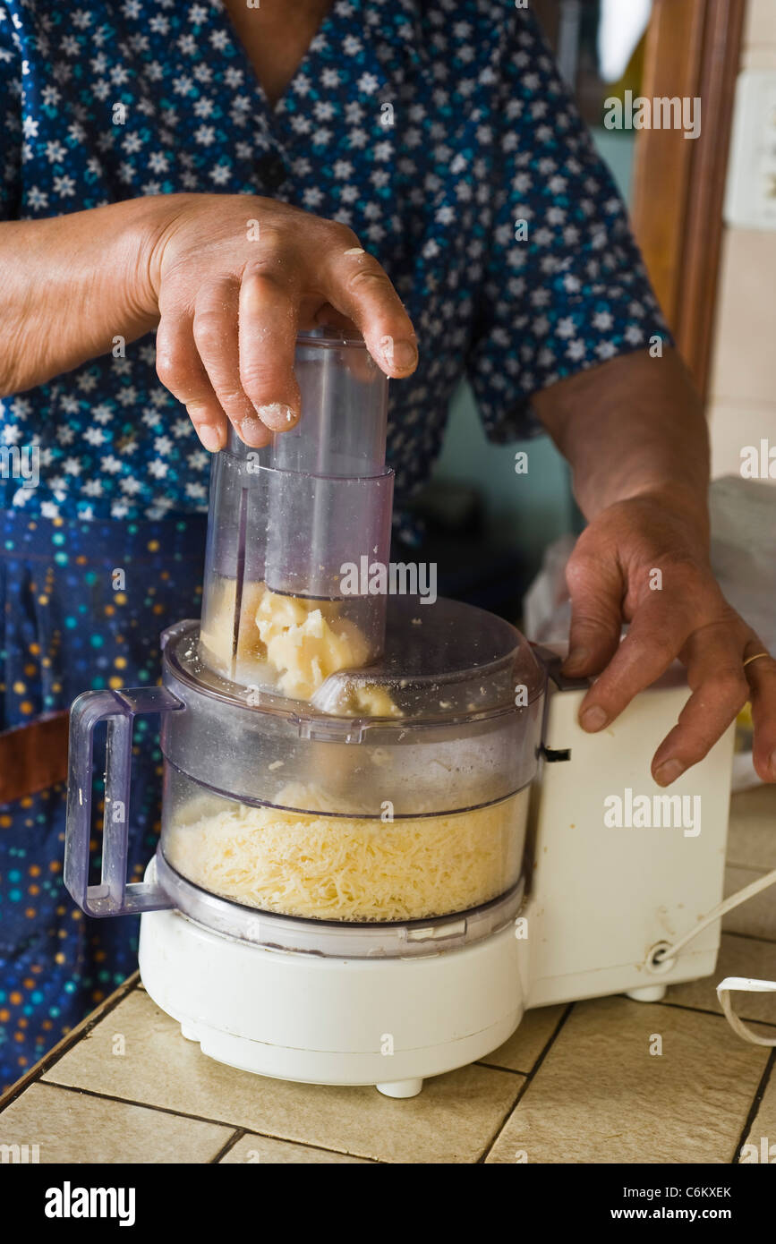 Using food processor to grate cheese Stock Photo - Alamy