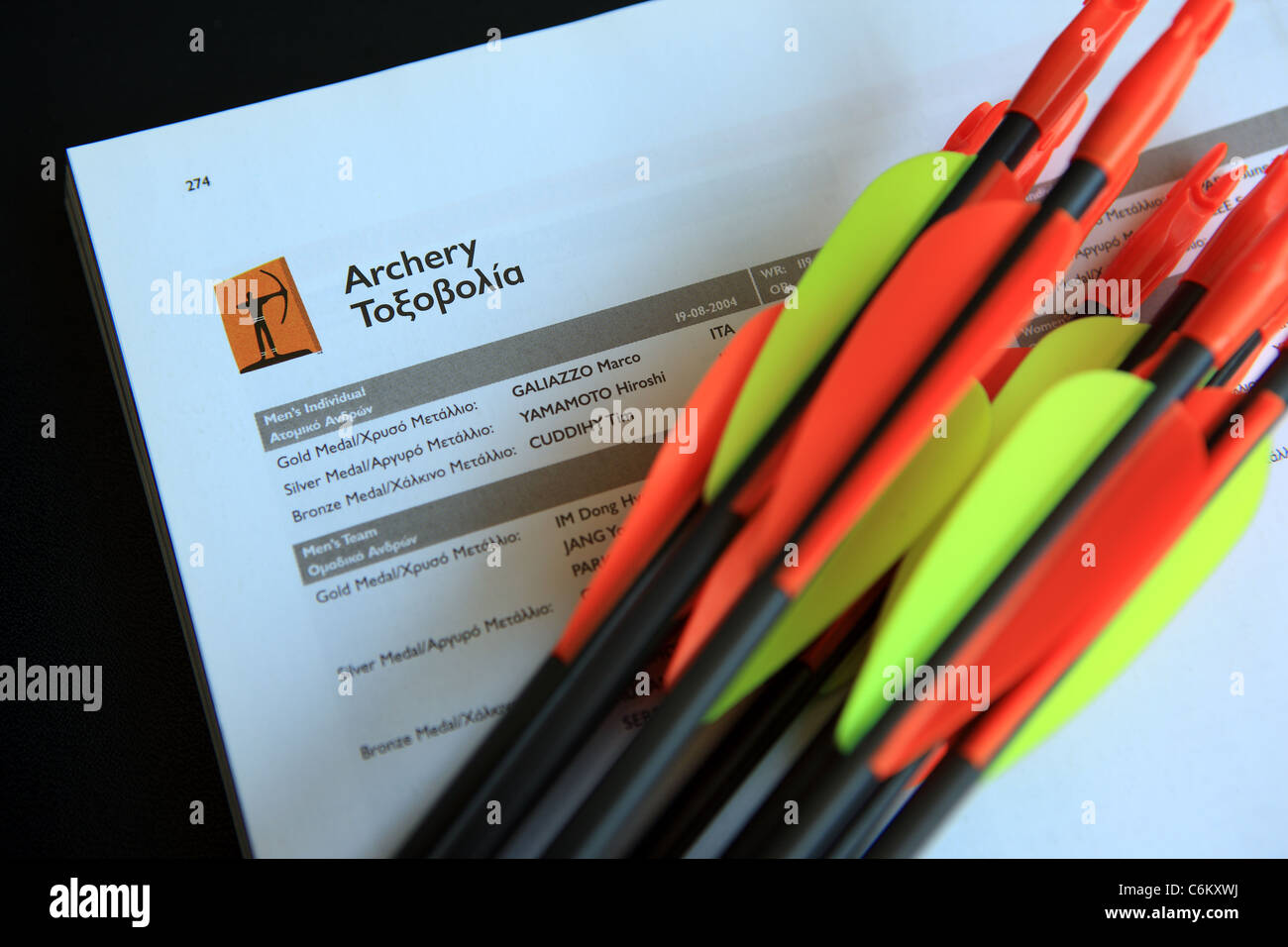 Archery arrows on top of Archery page from Athens 2004 Olympics Stock Photo