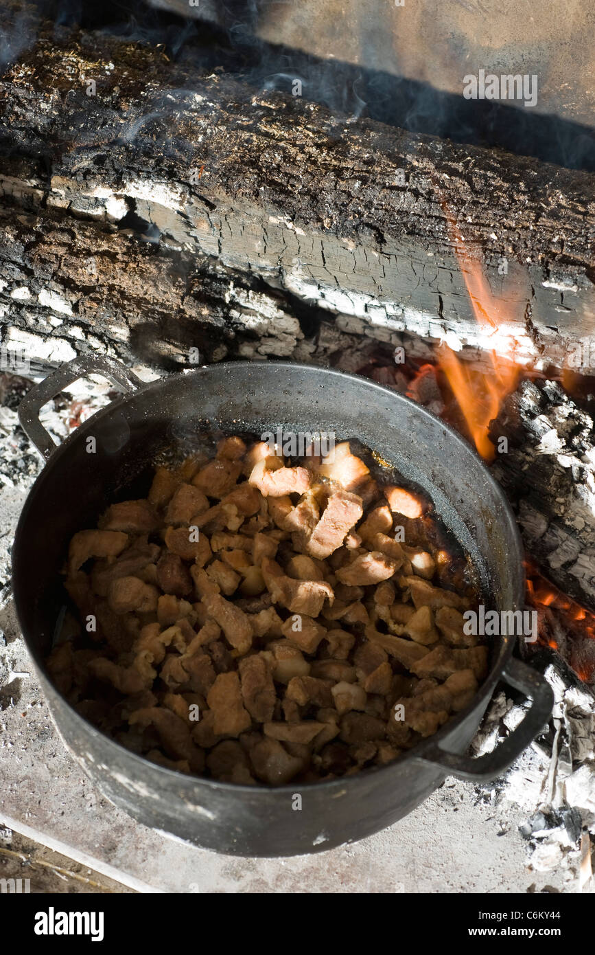 Caramel pork (thit kho) cooking over wood fire Stock Photo Alamy