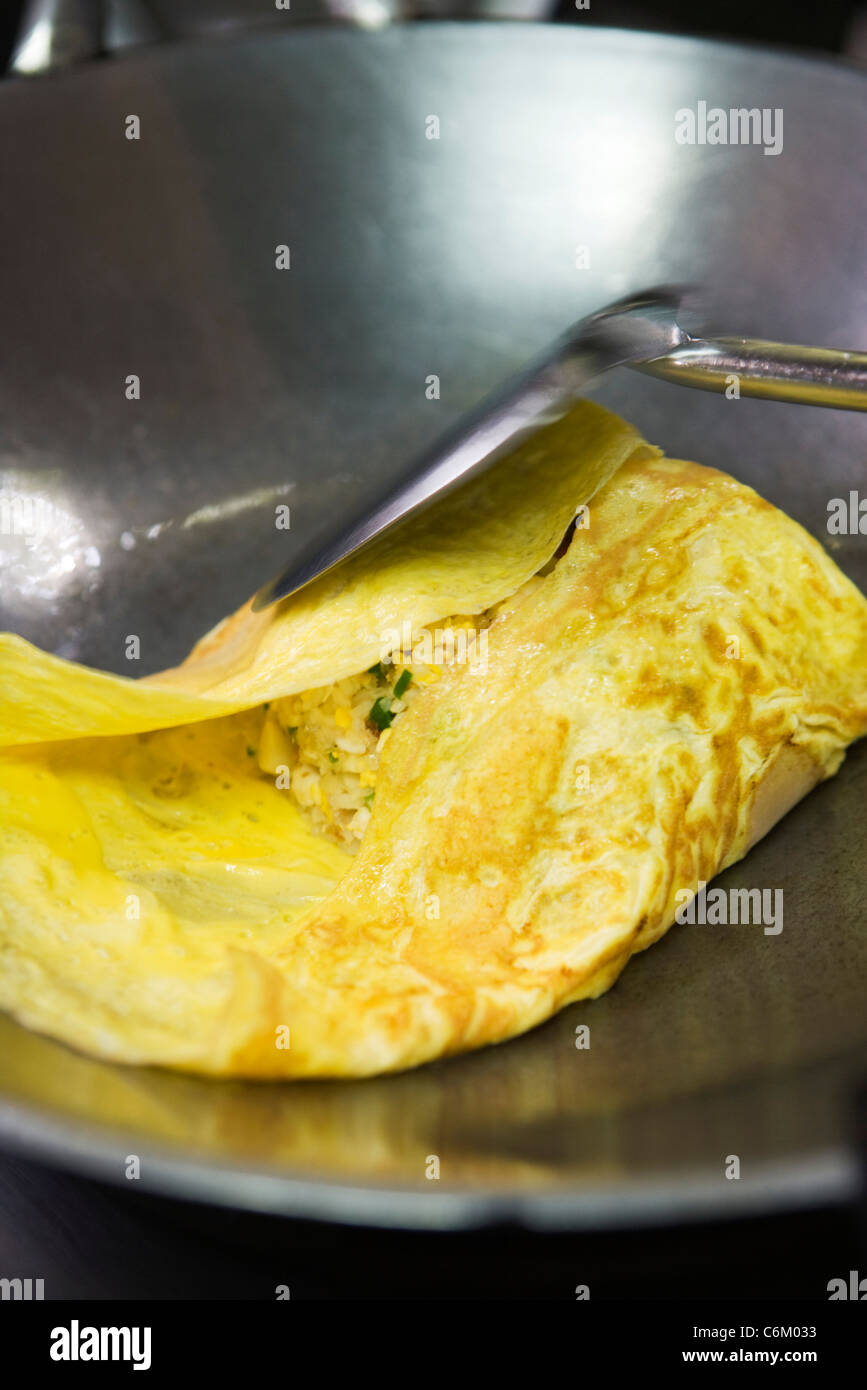 Making omelettes - folding over plain omelette using a large spatula Stock  Photo - Alamy
