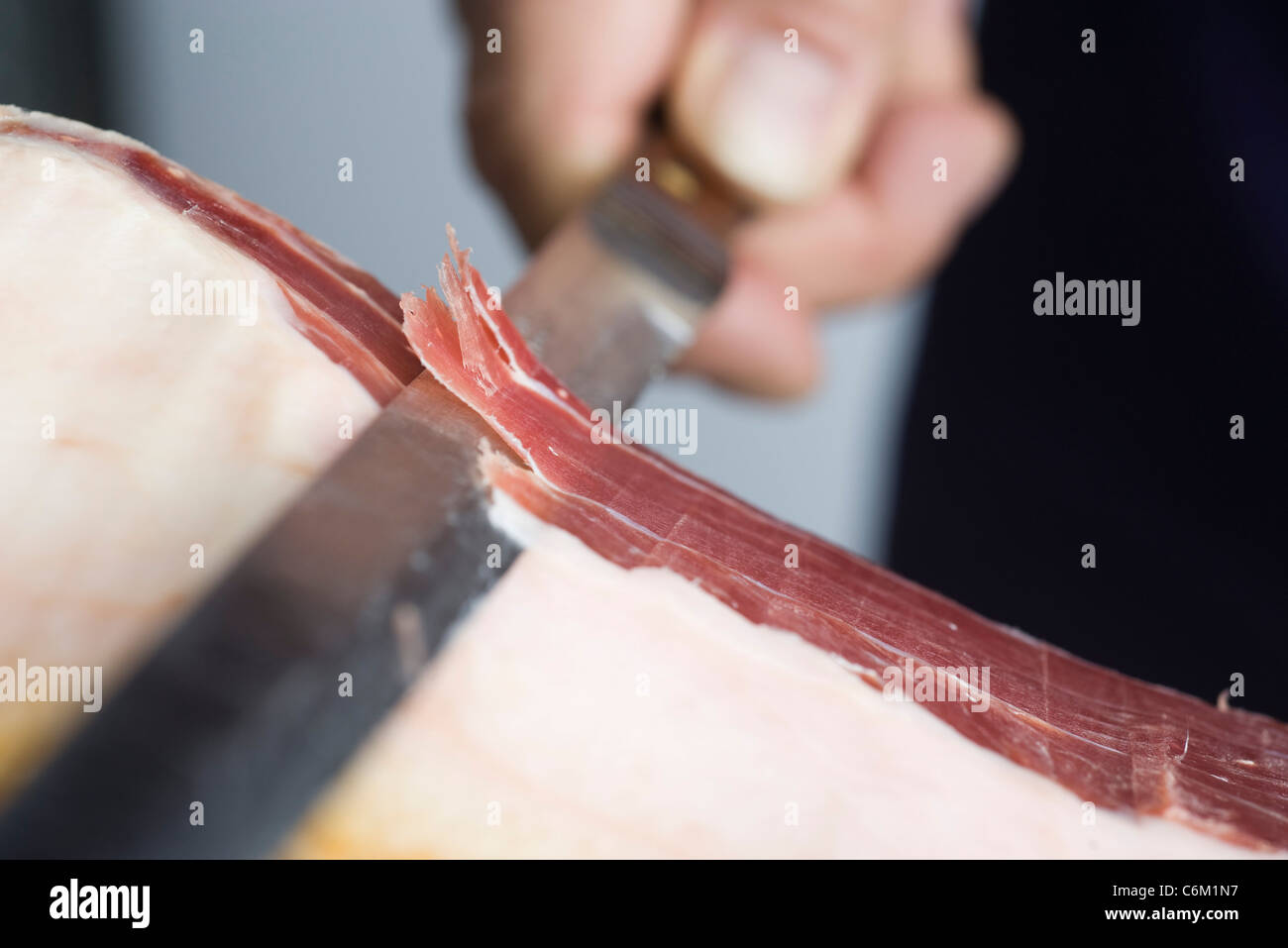 Slicing prosciutto, close-up Stock Photo