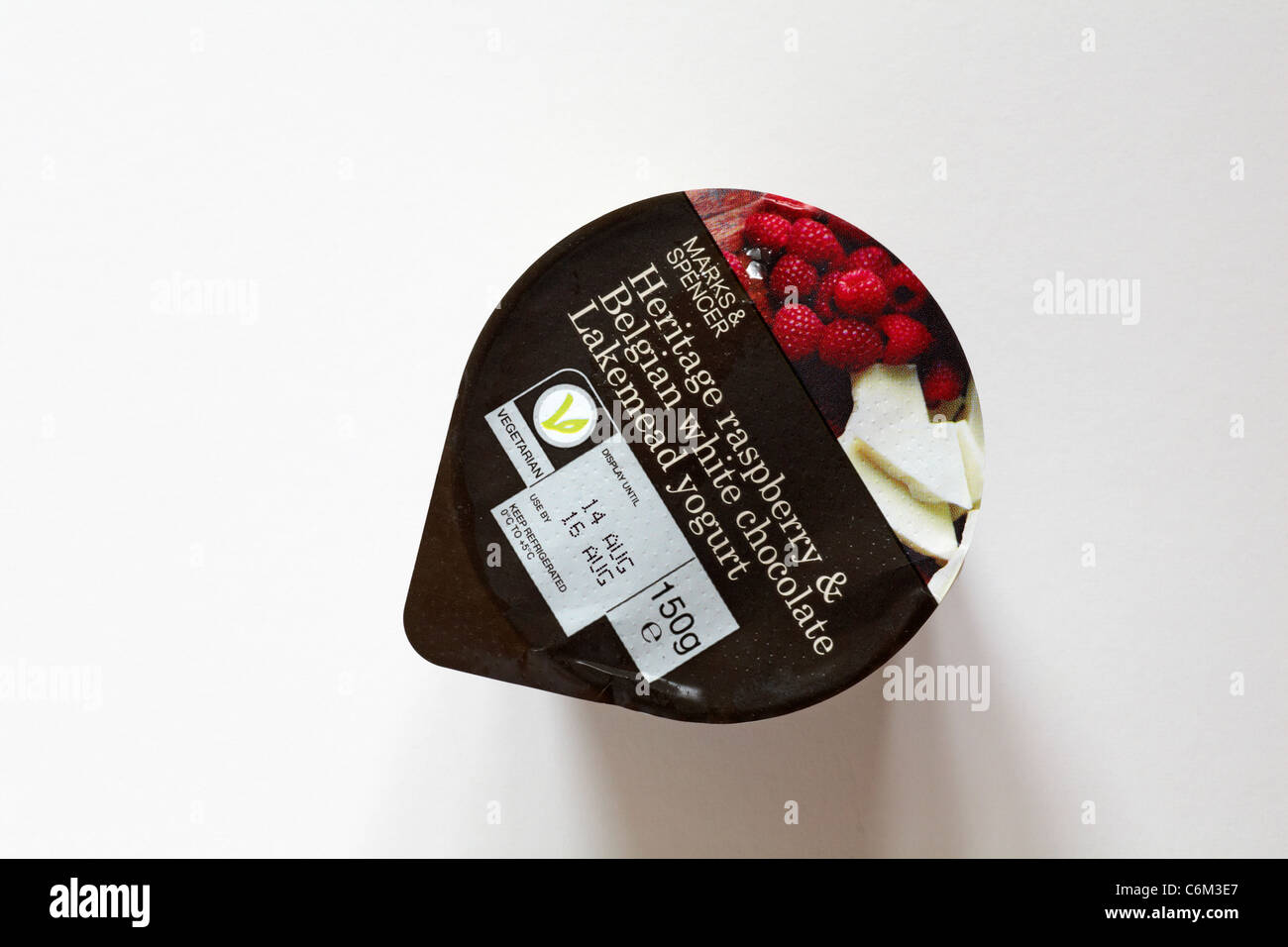 Tub of Heritage raspberry & Belgian white chocolate Lakemead yogurt isolated on white background - yoghurt Stock Photo