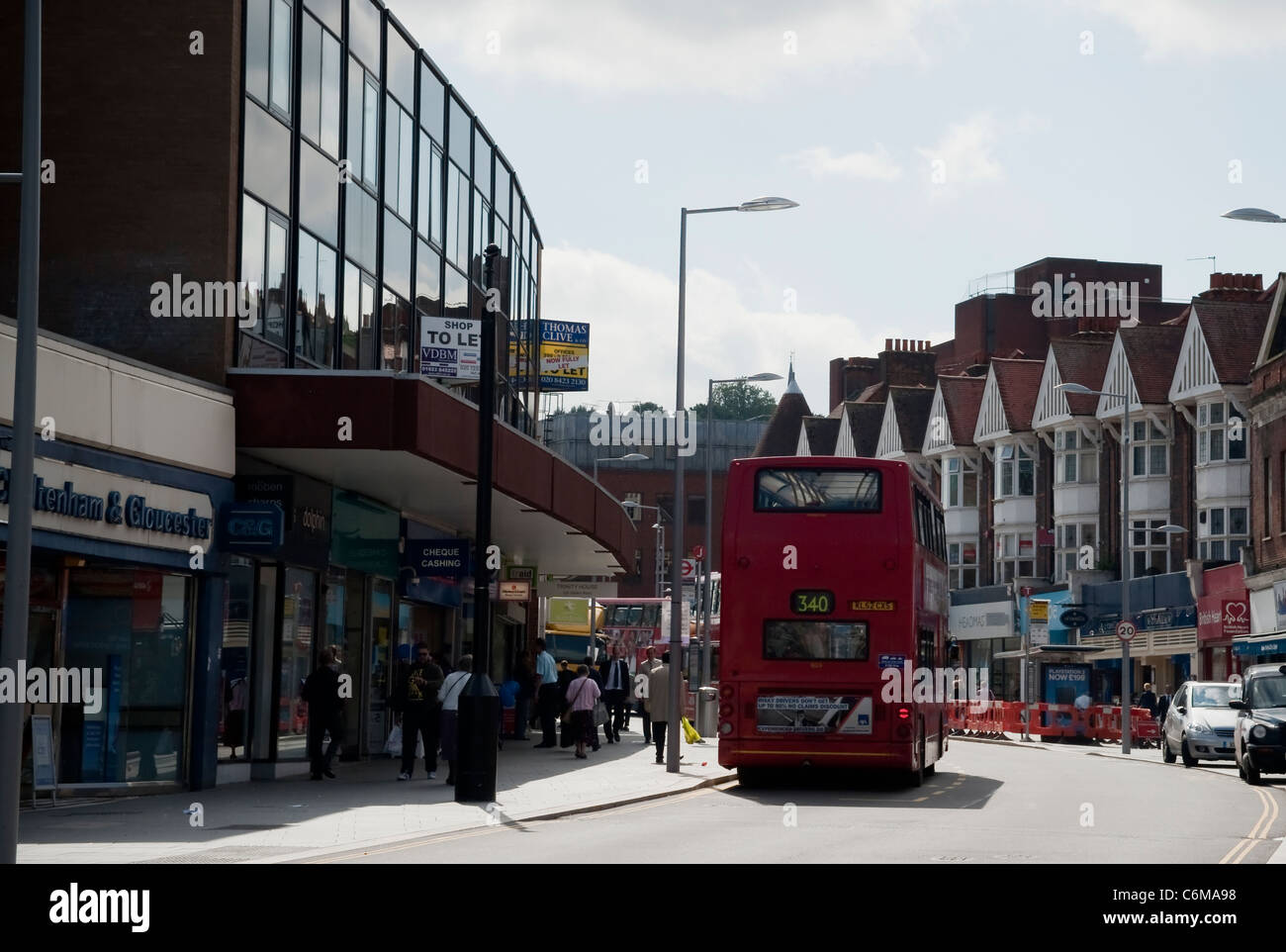 Harrow town centre new road lay out with a red bus and terraced houses