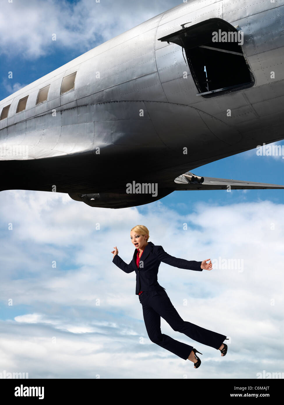 humorous image of woman falling from open hatch of airplane in flight Stock  Photo - Alamy
