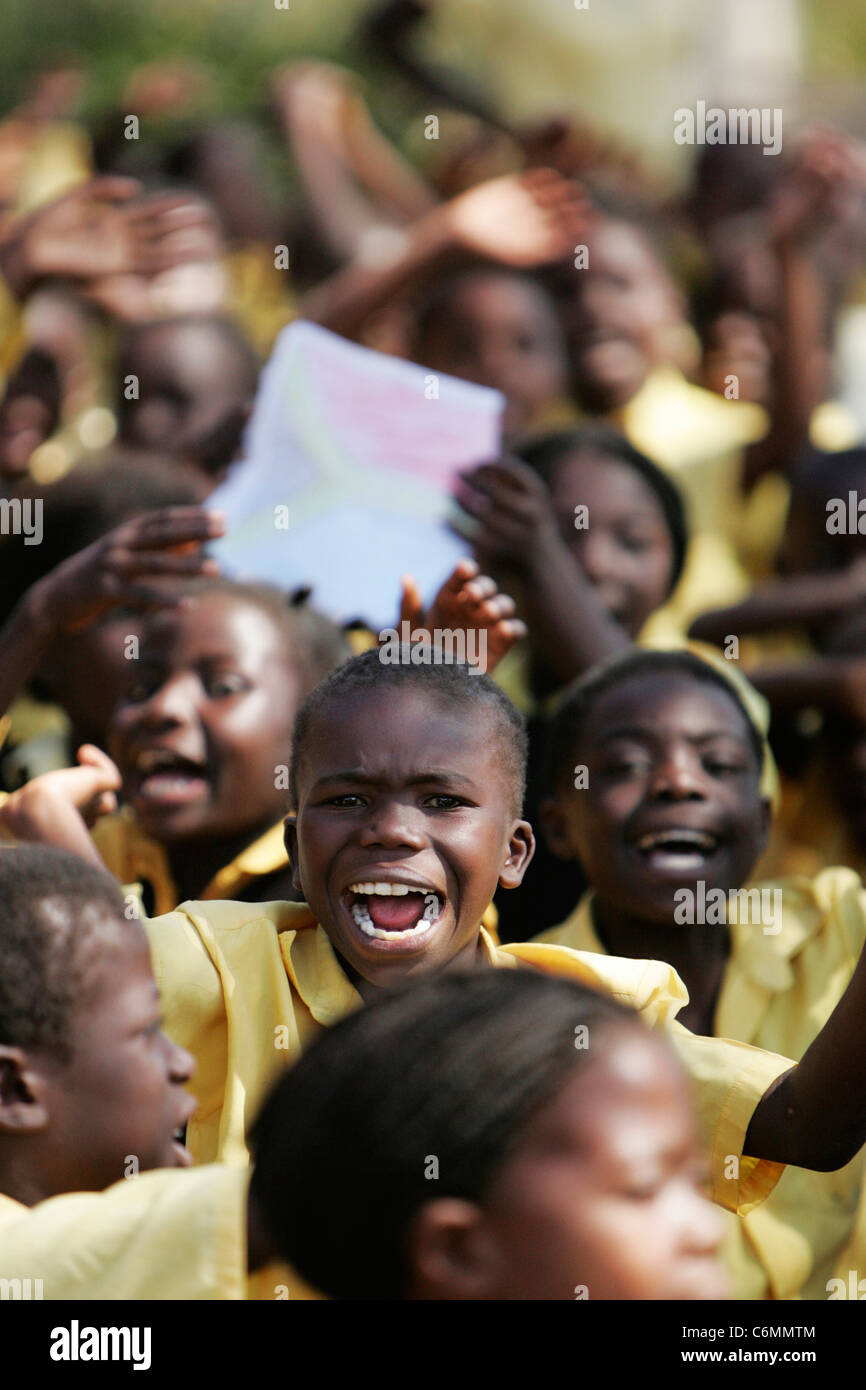 School children gathered together waving and cheering Stock Photo